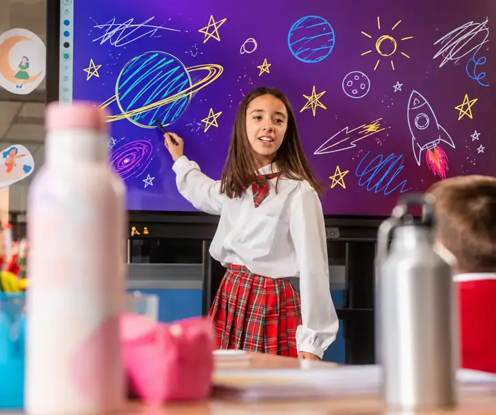 Student standing in front of a purple classroom screen with distracting marks
